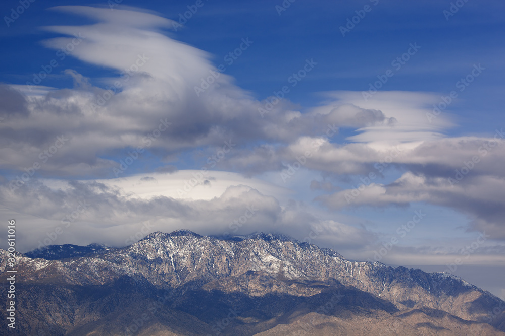 Winter landscape of lenticular clouds floating above the San Bernardino Mountains, Palm Springs, California, USA
