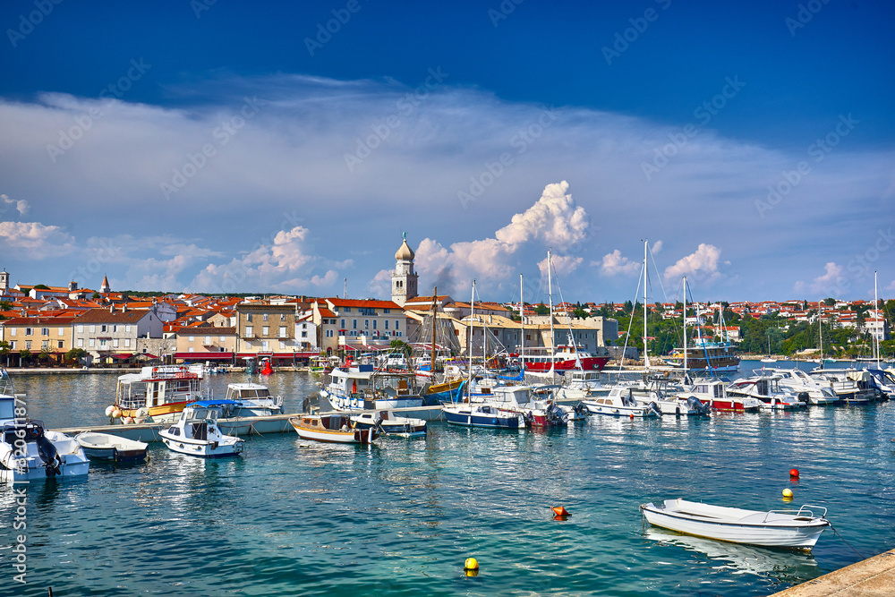 Krk is a Croatian island in the northern Adriatic Sea, located near Rijeka in the Bay of Kvarner and part of Primorje Gorski Kotar county. Famous touristic Krk town, Croatia, Europe. Yachts and boats.