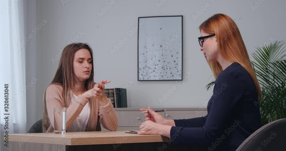 Psychologist working with young woman in office Psychologist working with young woman in office