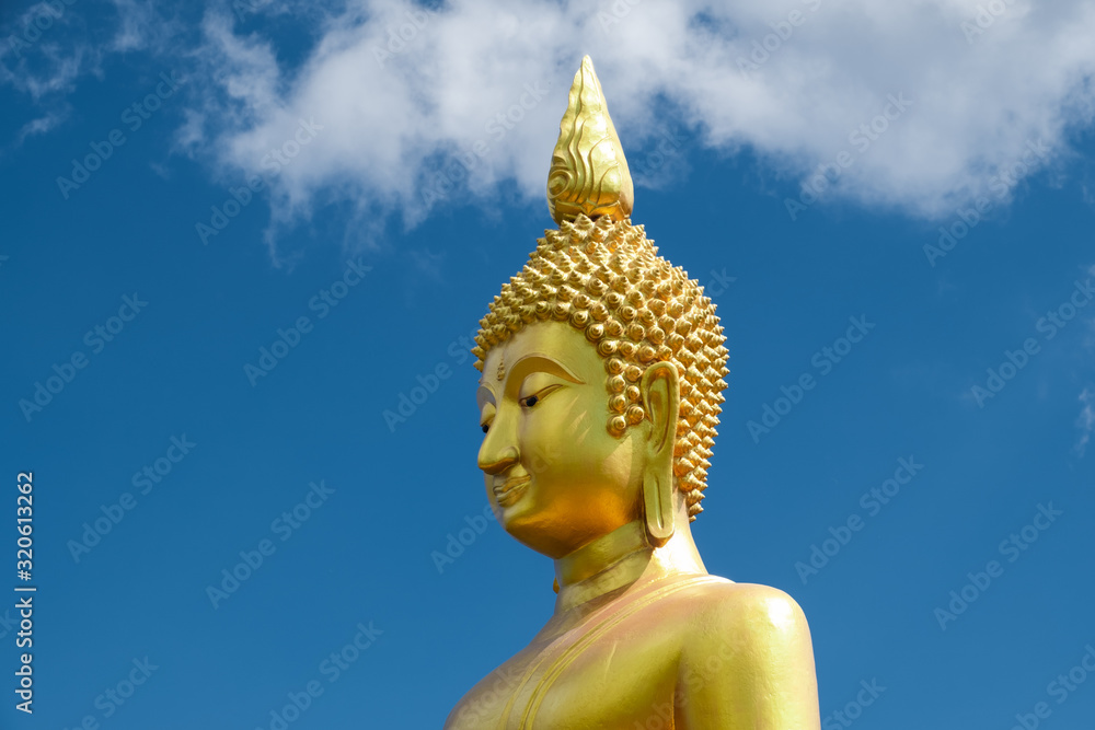 head and boy of Golden buddha statue against blue sky and clouds head and boy of Golden buddha statue against blue sky and clouds