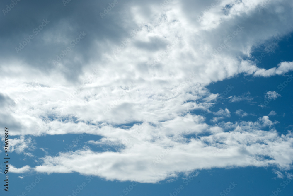 Blue sky with picturesque, white and gray clouds