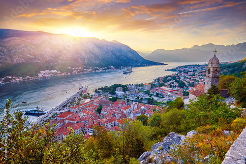 Fantastic aerial panoramic summer view from the mountain to the bay of Kotor, Mediterranean, Balkans, Montenegro, Europe. Traveling concept background. Incredible street lights in the sunset. 