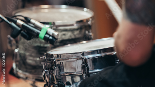 Drummer recording drum session in studio