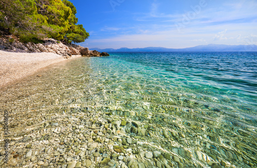 Amazing seascape of Adriatic sea. Luchica beach Croatia, Europe. Colorful summer view of small beach. Croatian coast with clear water and pine trees around. Tropical viewpoint for design postcard.