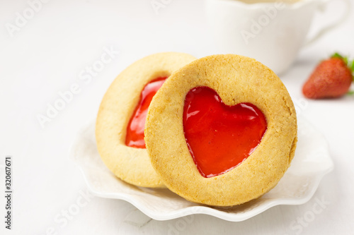 Homemade Cookies with a strawberry Jam Heart and a cup