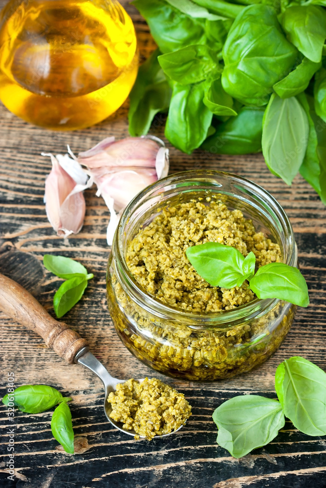 Pesto sauce and ingredients over wooden rustic background Pesto sauce and ingredients over wooden rustic background