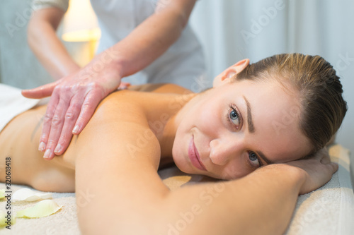 beautiful young woman having back massage