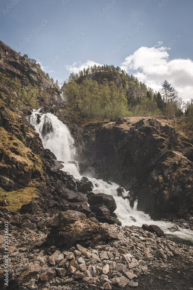 Beautiful landscape of nature in Norway,  latefossen waterfall by the road  in the forest