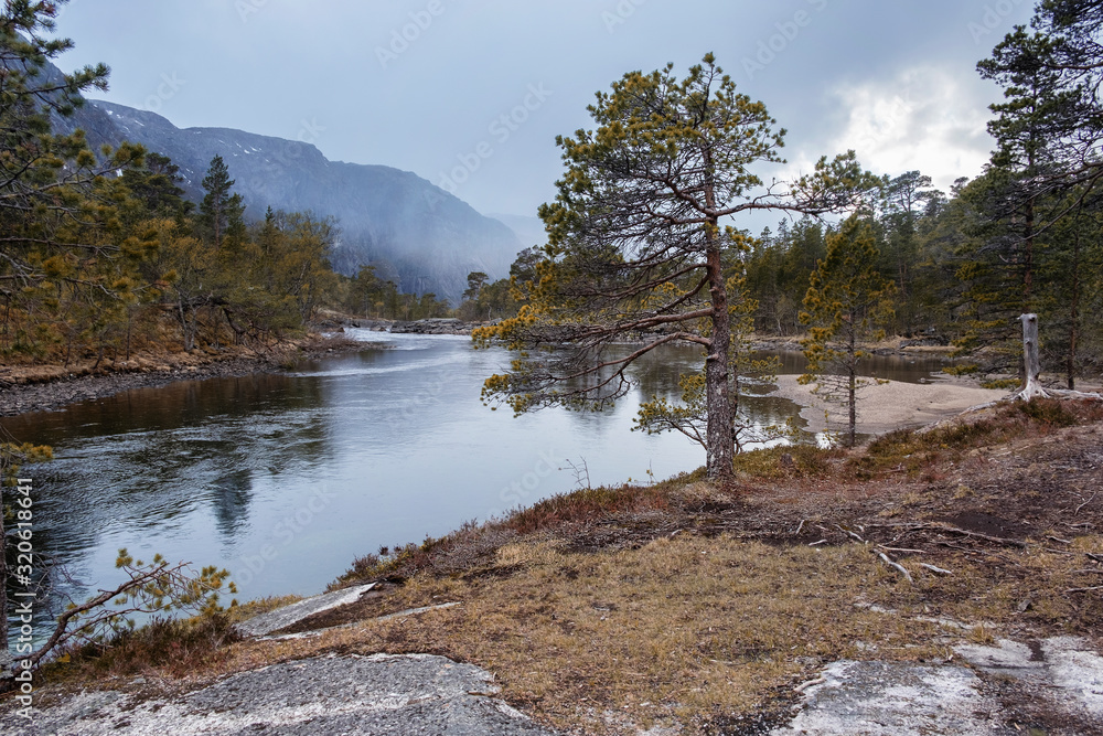 Norway nature landscape, river in the national park valley of the Husedalen waterfalls at autumn evening