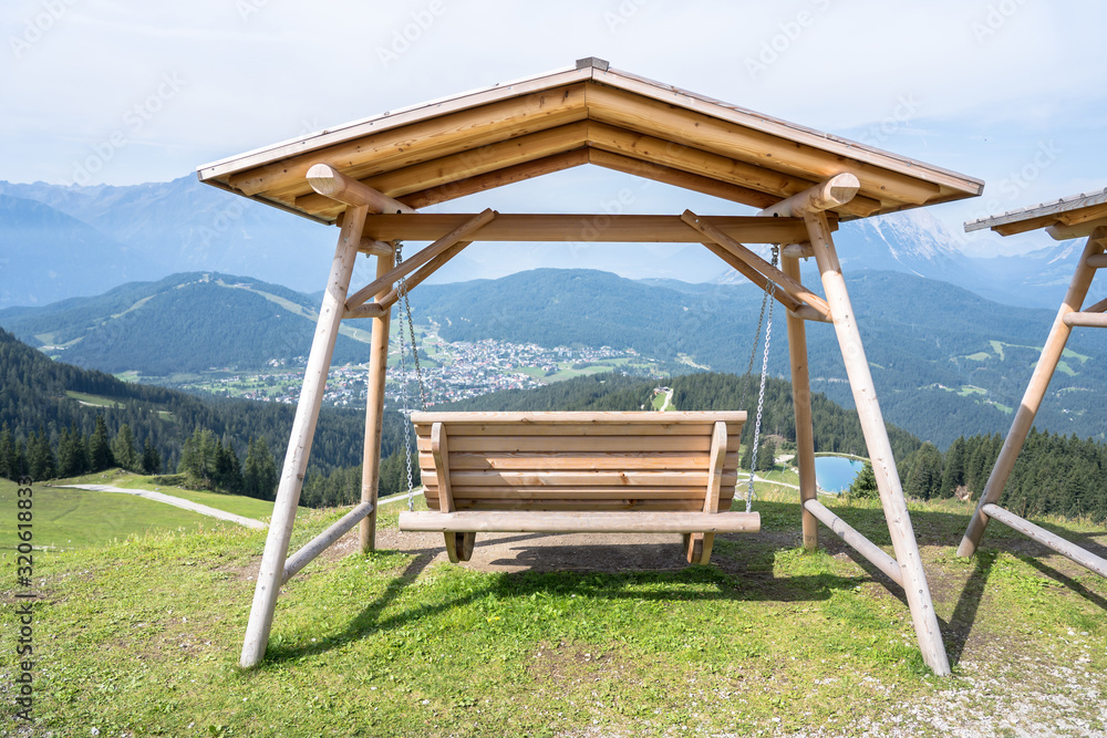 Wooden seesaw swing in Seefeld, Tirol, Austria Wooden seesaw swing in Seefeld, Tirol, Austria