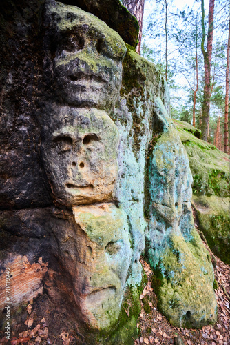 Rock sculptures of giant heads and other artworks Harfenice (Harfenist) carved into the sandstone cliffs in pine forest above village Zelizy by Vaclav Levy, Central Bohemia, Kokorin, Czech republic © Petr Bonek