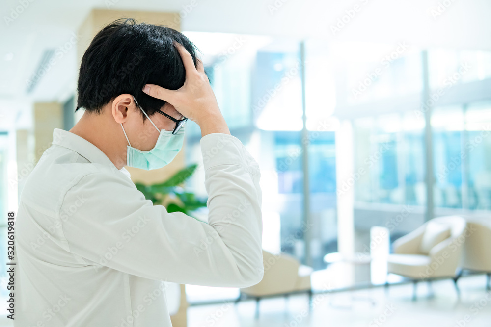 Male Asian patient wearing surgical mask coughing at waiting area in hospital or medical center. Medical exam or body check up. Wuhan coronavirus outbreak prevention. Health care concept Male Asian patient wearing surgical mask coughing at waiting area in hospital or medical center. Medical exam or body check up. Wuhan coronavirus outbreak prevention. Health care concept