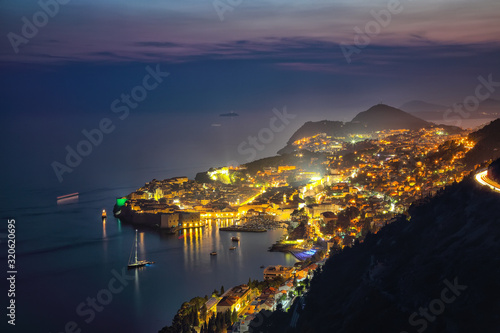 Aerial panoramic view of the old town of Dubrovnik in beautiful evening twilight at dusk.