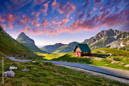 Fototapeta Naklejka Na Ścianę i Meble -  Amaizing sunset view on Durmitor mountains, National Park, Mediterranean, Montenegro, Balkans, Europe.  Bright summer view from Sedlo pass. Instagram picture. Way through the mountain. Colored clouds.