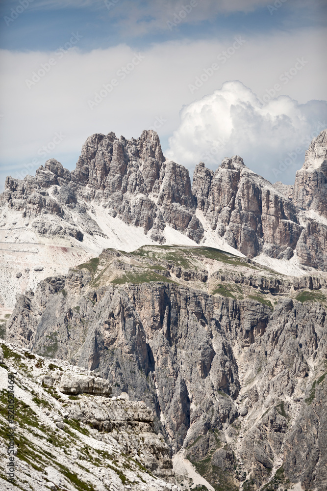 Hike the mountains of Passo Giau. The world famous Dolomites peaks in South Tyrol in the Alps of Italy. Belluno in Europe mountain scenery. Green fields