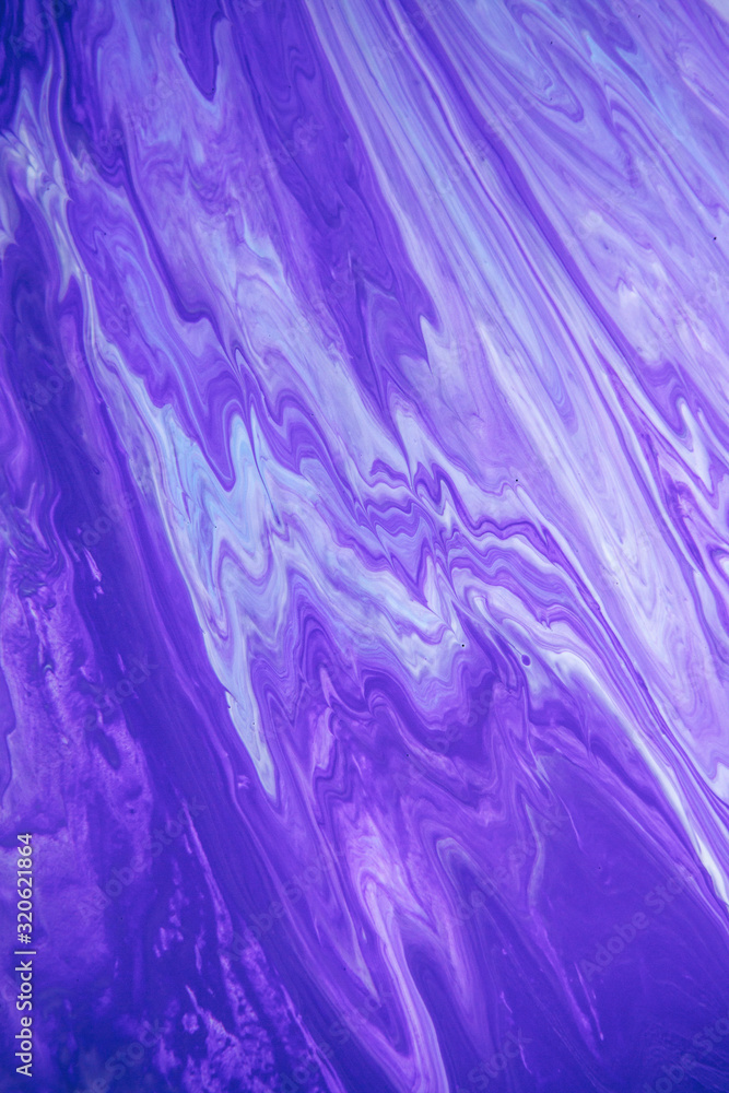 Acrylic paint liquid in trend purple and blue color mix background.
