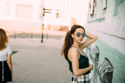 Sexy girl in a T-shirt and short shorts near the building © prokop.photo