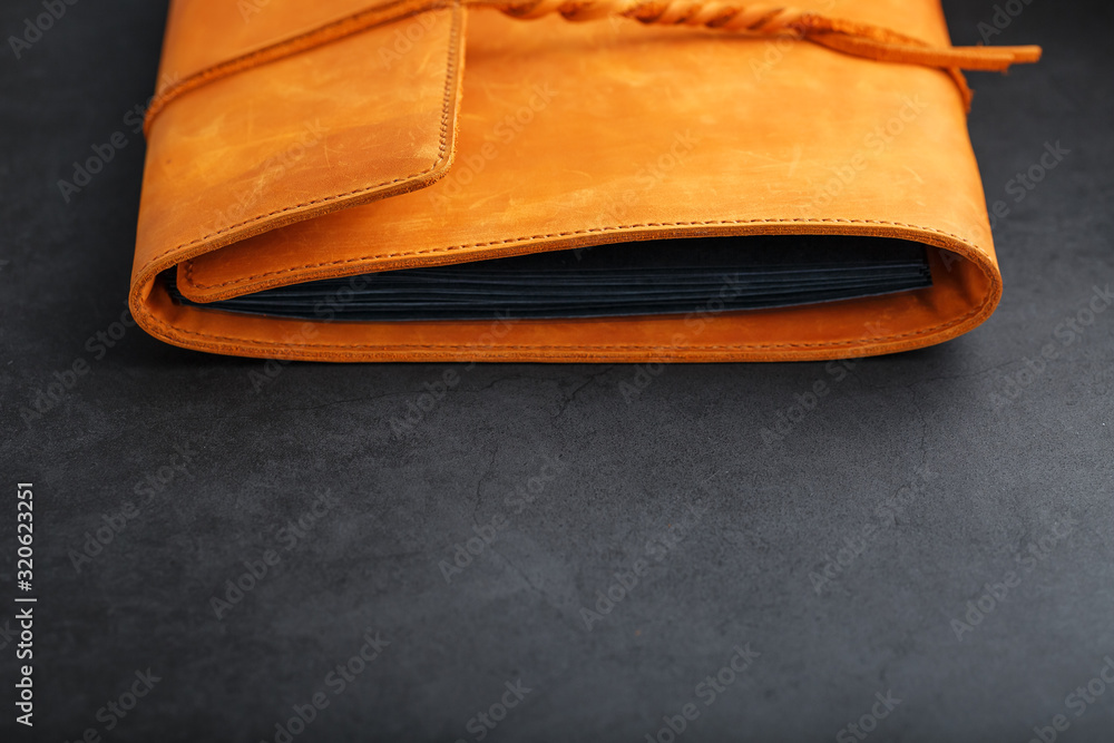 The album cover is made of brown genuine leather, handmade on a black background.