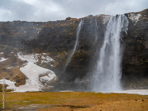 Fantastic waterfall in Iceland, winter tourism,