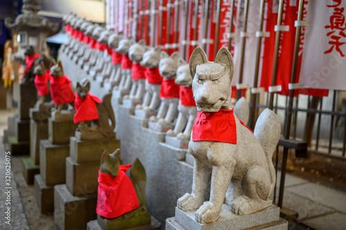 Kitsune fox guardian statues at Toyokama Inari Tokyo Betsuin , Japan photo