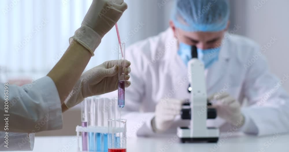 Scientists working with samples in modern laboratory Scientists working with samples in modern laboratory
