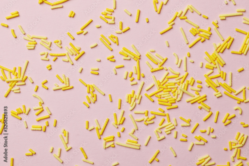 Colorful sprinkles on a pink background, top view with copy space. Easter holiday. Birthday celebration. Colorful sprinkles on a pink background, top view with copy space. Easter holiday. Birthday celebration.