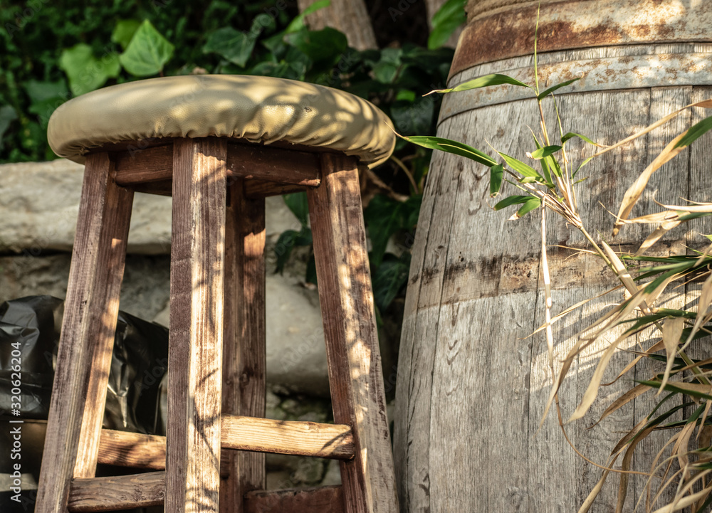 wooden bar stool and rustic wine barrel