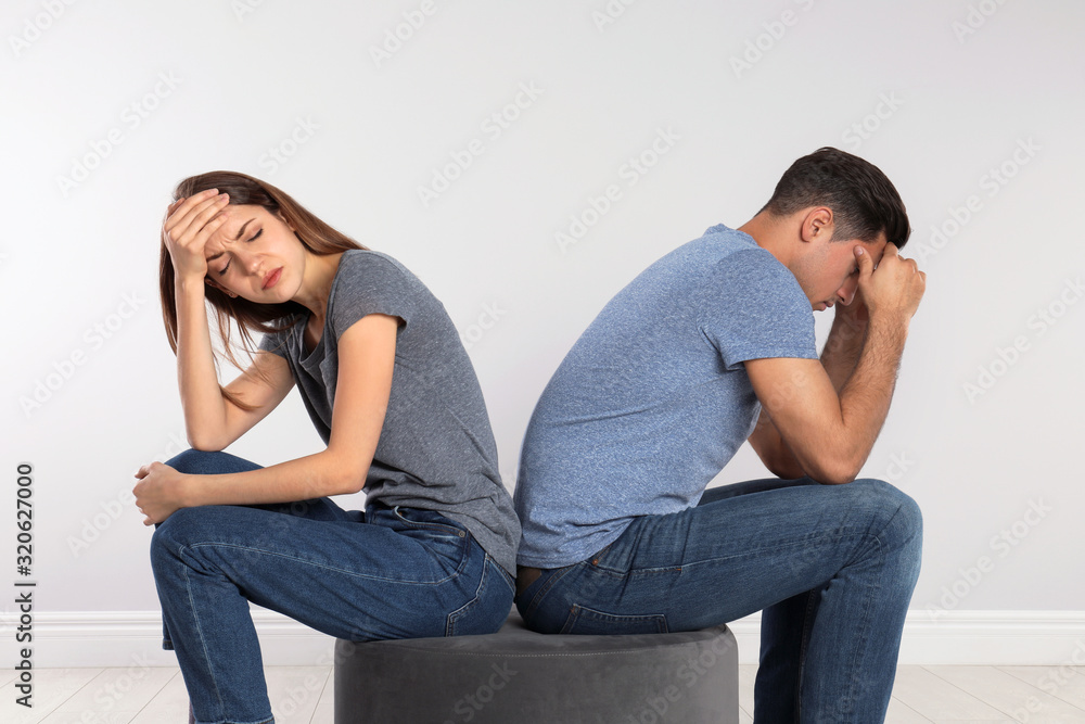 Couple with relationship problems on light background Couple with relationship problems on light background