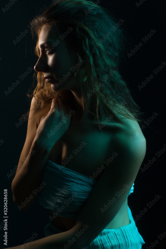 High Fashion model woman in colorful bright lights posing, portrait of a beautiful girl. Artistic colorful design. Party concept High Fashion model woman in colorful bright lights posing, portrait of a beautiful girl. Artistic colorful design. Party concept