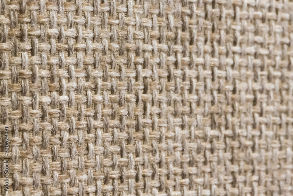 Light brown hand weaving matting tweed fabric texture. Closeup fragment Light brown hand weaving matting tweed fabric texture. Closeup fragment