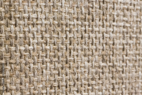 Light brown hand weaving matting tweed fabric texture. Closeup fragment