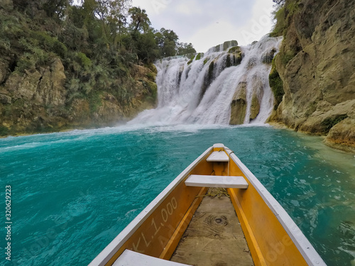 yellow boat point of view (EL SALTO-EL MECO) san luis potosi México, hermosa cascada Turquoise water in a river and cliffs of the reserve.  photo