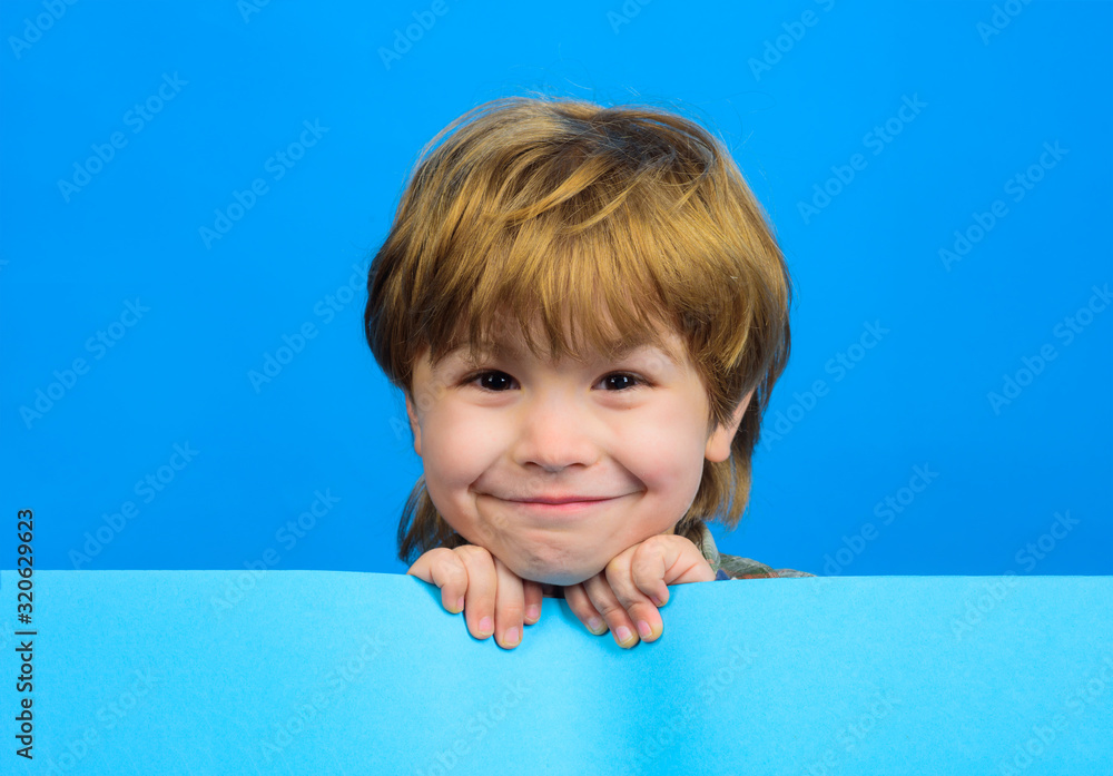 Smiling boy holds blank board. Child boy holds empty billboard. Little boy holds blank advertising banner. Funny little boy with empty board for your text. Advertising. Children's goods. Smiling boy holds blank board. Child boy holds empty billboard. Little boy holds blank advertising banner. Funny little boy with empty board for your text. Advertising. Children's goods.