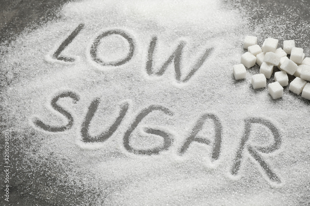 Composition with phrase LOW SUGAR on grey table Composition with phrase LOW SUGAR on grey table