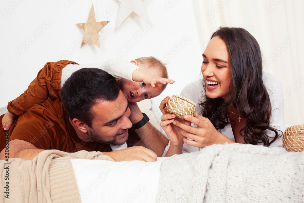 young happy family together having fun in bed, lifestyle people concept at home