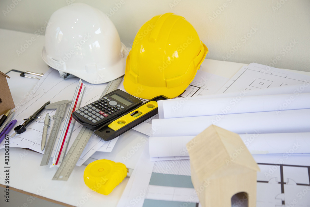 Desk of Architectural working project in construction site,With drawing equipment concept. Desk of Architectural working project in construction site,With drawing equipment concept.