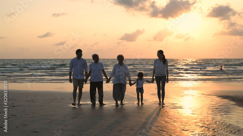 Holiday concept. Big family walking hand in hand on the beach. 4k Resolution.