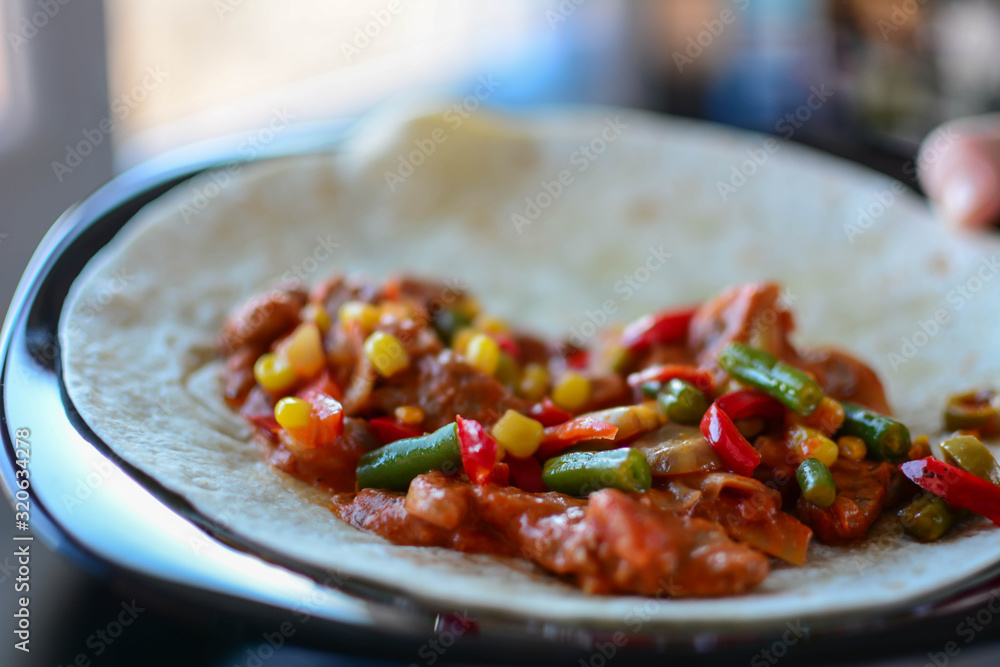 Close-up, making tacos at home in kitchen. Selective focus Close-up, making tacos at home in kitchen. Selective focus