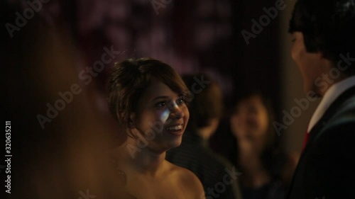 A teenage boy and girl dancing at a senior prom high school dance