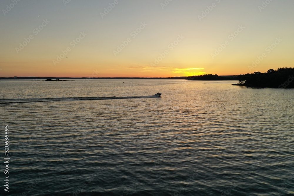  Sunset over the lake in nature on a sunny summer eveni
