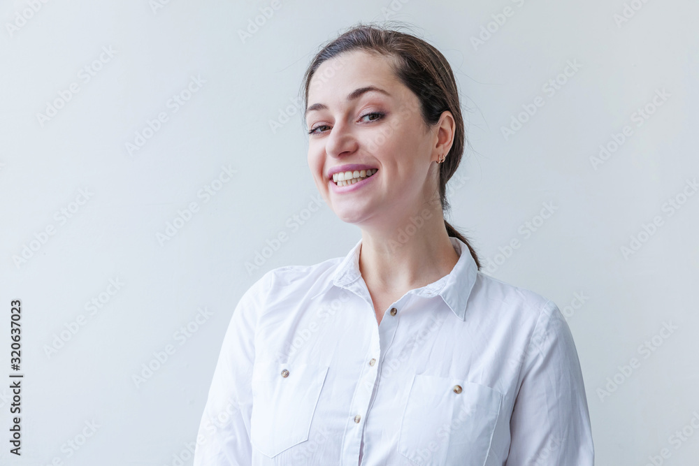 Happy girl smiling. Beauty portrait young happy positive laughing brunette woman on white background isolated. European woman. Positive human emotion facial expression body language Happy girl smiling. Beauty portrait young happy positive laughing brunette woman on white background isolated. European woman. Positive human emotion facial expression body language