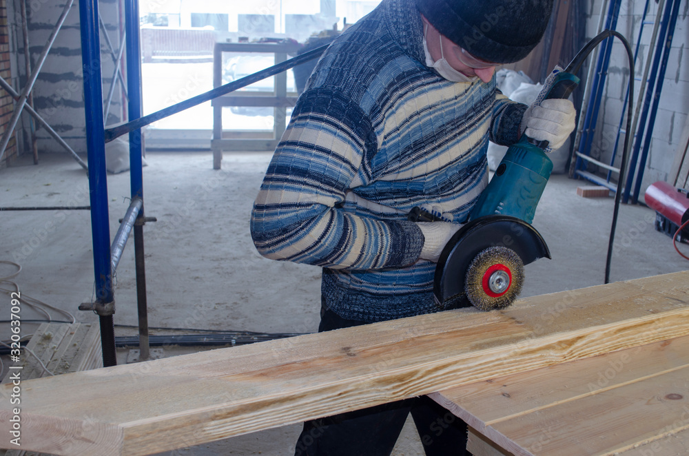 man handles construction boards at a construction site man handles construction boards at a construction site