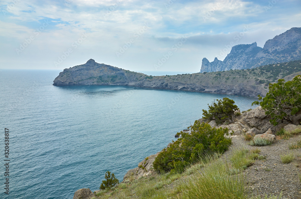 A tourist route along a trail in the mountains of the southern coast of Crimea, a beautiful view of the Black Sea and rocks. Golitsyna trail, Republic of Crimea