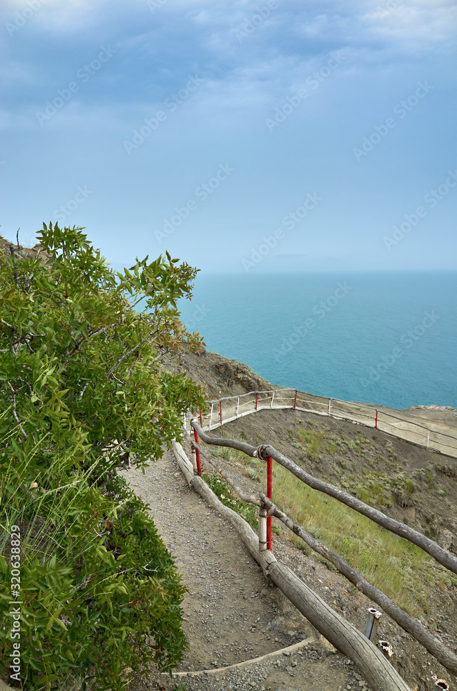 A tourist route along a trail in the mountains of the southern coast of Crimea, a beautiful view of the Black Sea and rocks. Golitsyna trail, Republic of Crimea