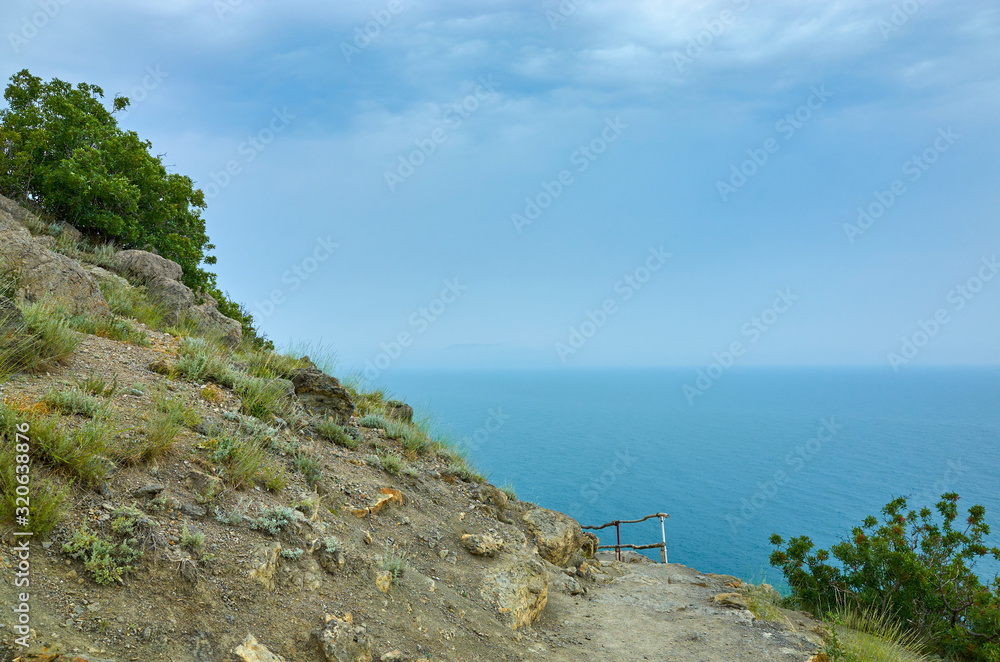 A tourist route along a trail in the mountains of the southern coast of Crimea, a beautiful view of the Black Sea and rocks. Golitsyna trail, Republic of Crimea