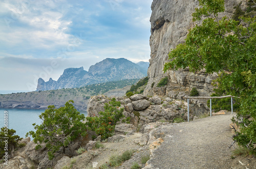 Obraz na płótnie A tourist route along a trail in the mountains of the southern coast of Crimea, a beautiful view of the Black Sea and rocks. Golitsyna trail, Republic of Crimea w salonie