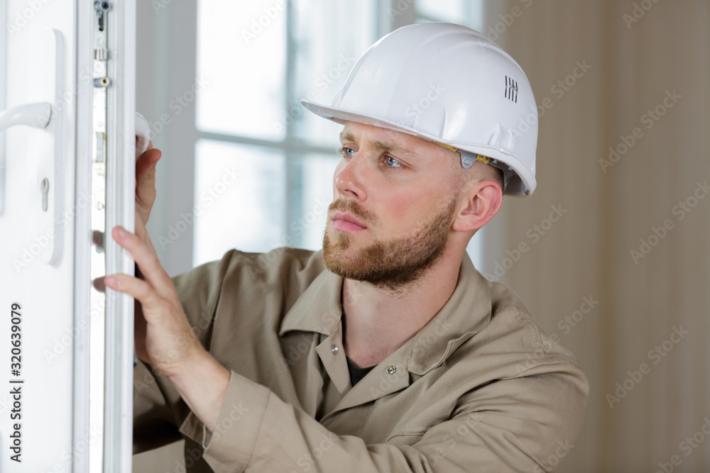 male builder working on a window male builder working on a window