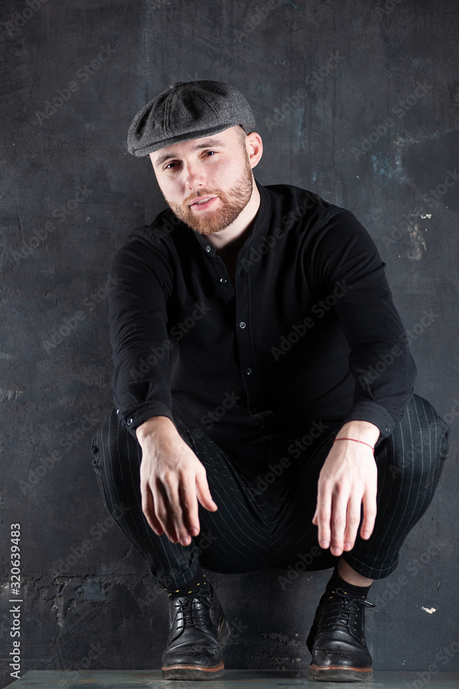 Portrait of handsome business man. Boy sitting on table. Portrait of handsome business man. Boy sitting on table.