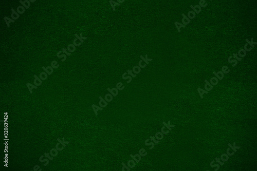 fleecy fabric background of felted texture, dark green cloth for poker table