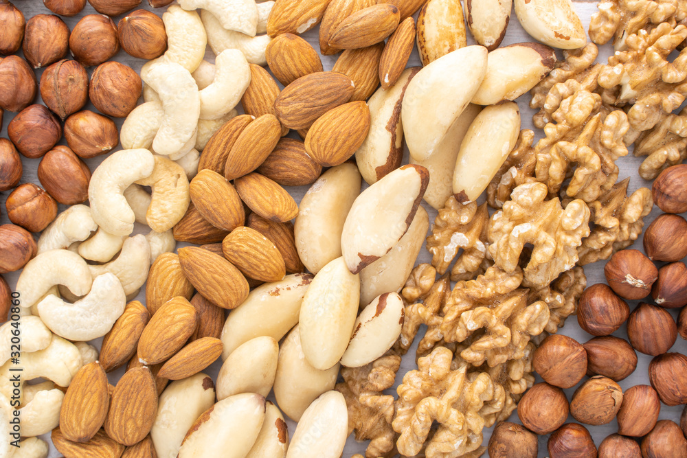 Different nuts in the row on the table, stock photo. Different nuts in the row on the table, stock photo.